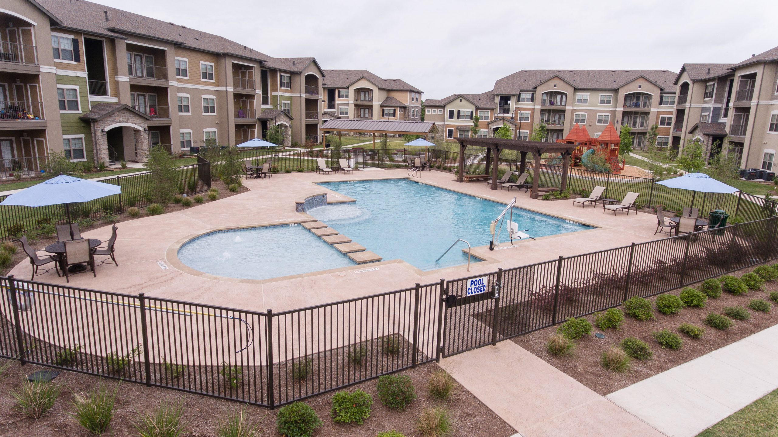 Overview of pool and courtyard area surrounded by apartment buildings